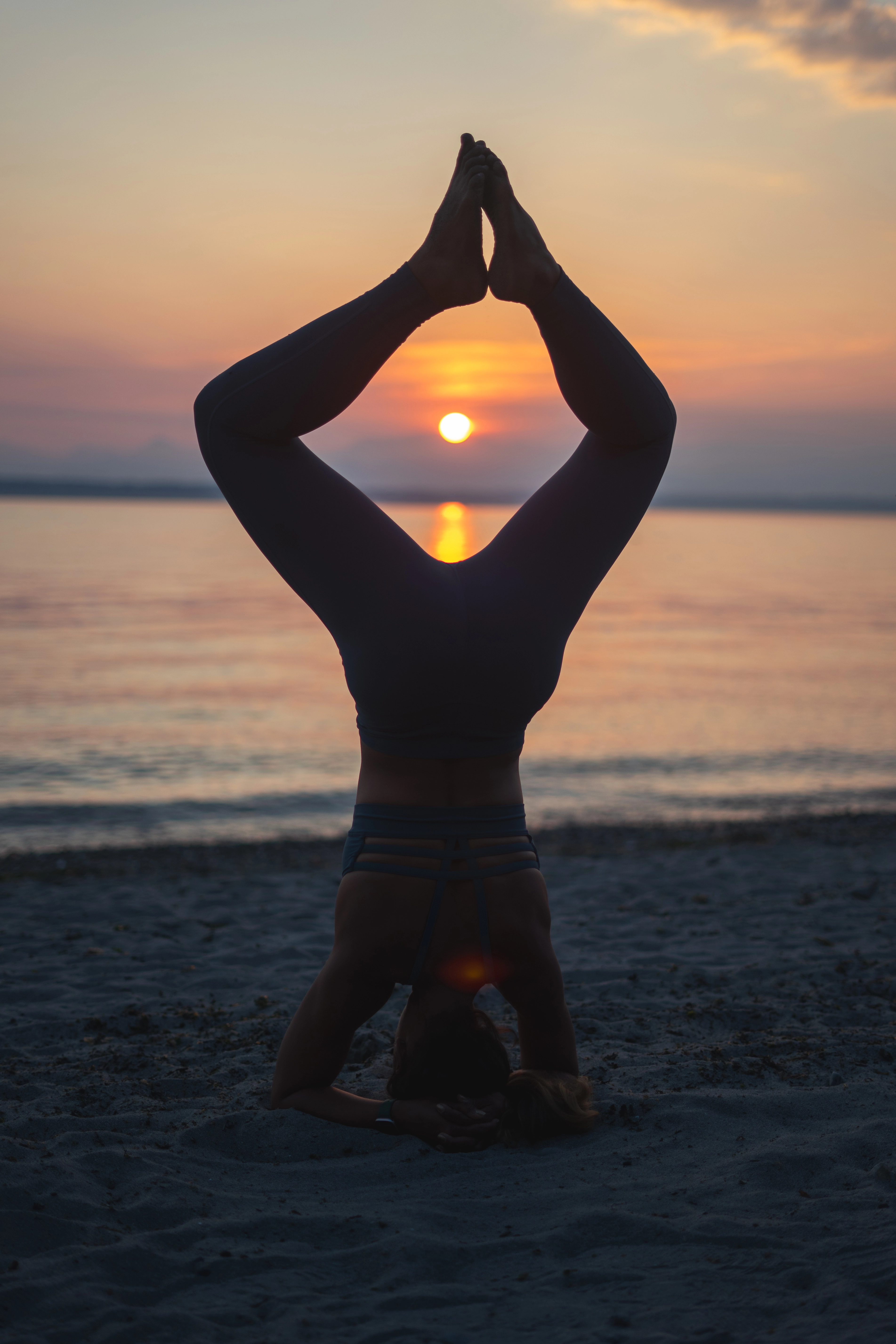 Cassie doing a headstand on the beach